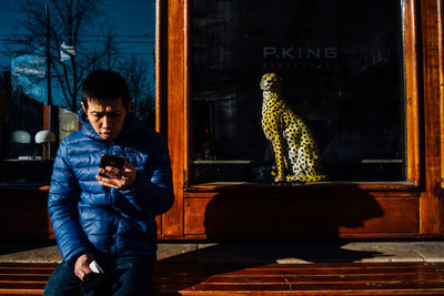 Portrait of man using mobile phone at night