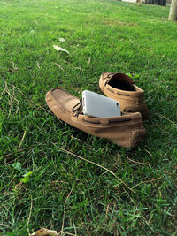 High angle view of smart phone on grass