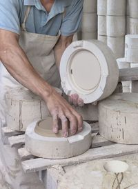 Midsection of man working in kitchen