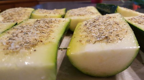 Close-up of cucumber slices with garnish on table