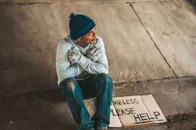 Full length of a man sitting on road