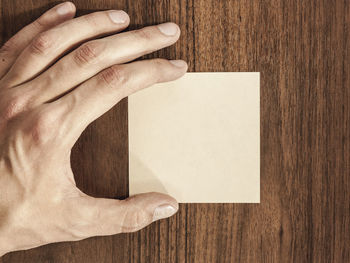 Directly above shot of human hand on table