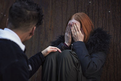 Boy comforting crying young woman