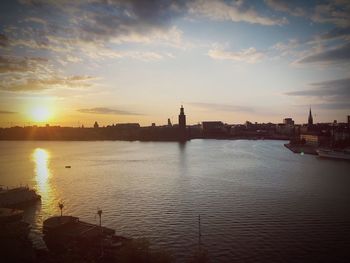 City at waterfront during sunset