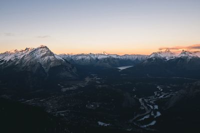 Scenic view of snowcapped mountains against sky during sunset