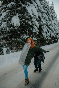 Full length of woman walking on snow covered road
