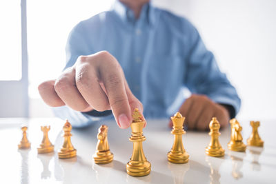 Low angle view of man playing on chess board