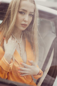 Portrait of young woman in car