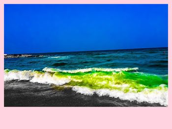 Scenic view of beach against clear blue sky