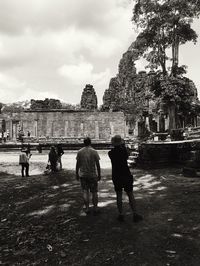 Rear view of people in front of building