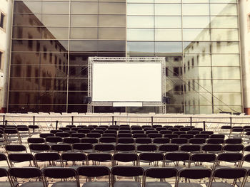 Empty chairs and tables in building