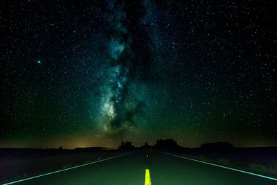 Scenic view of road against sky at night