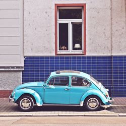 Vintage car against blue wall