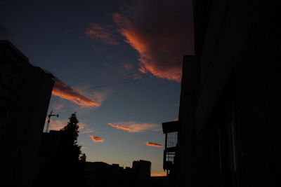 Low angle view of silhouette buildings against sky during sunset