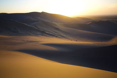 Scenic view of desert against sky during sunset