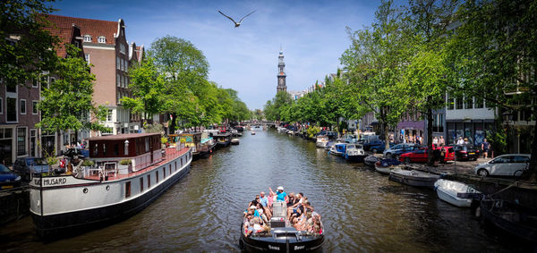 Boats in canal along city