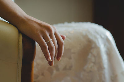 Close-up of bride showing ring in hand 