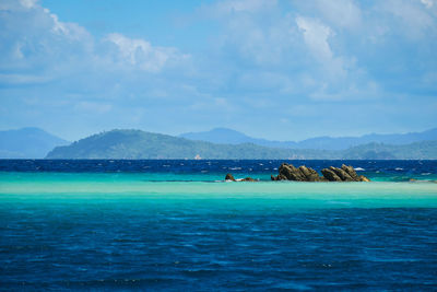 Scenic view of sea against cloudy sky