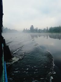 Scenic view of lake against sky during winter