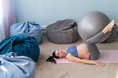 Young woman lying down on bed at home