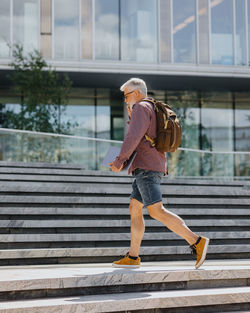 Side view of man walking on steps