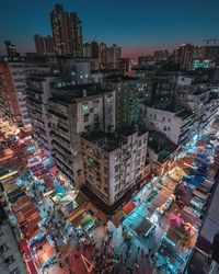 High angle view of illuminated buildings in city at night