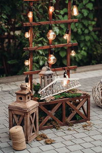 Close-up of lantern on table against trees