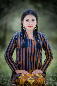 Portrait of young woman standing outdoors