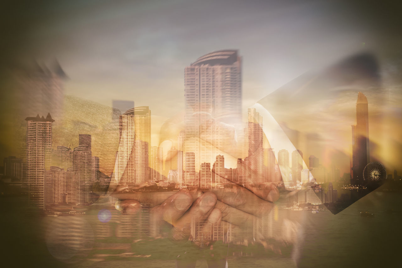 DIGITAL COMPOSITE IMAGE OF CITY AND BUILDINGS AGAINST SKY