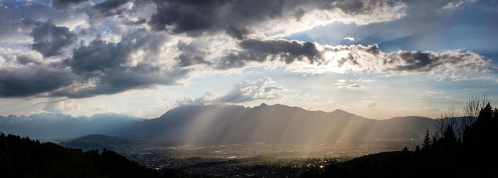Scenic view of mountains against cloudy sky