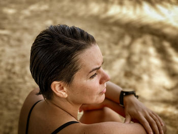 Beautiful woman looking away at beach 