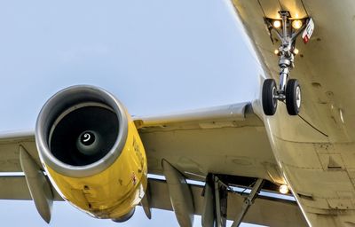 Low angle view of airplane on airport runway against sky