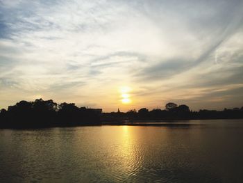 Scenic shot of calm lake at sunset