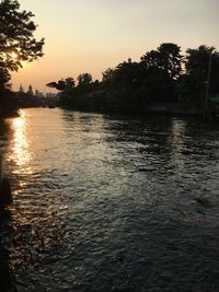 Scenic view of lake against sky at sunset