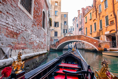 Riding a traditional gondola down the narrow canals in venice, italy.