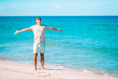 Full length of woman standing on beach