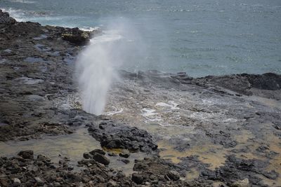 Waves splashing on rocks at shore