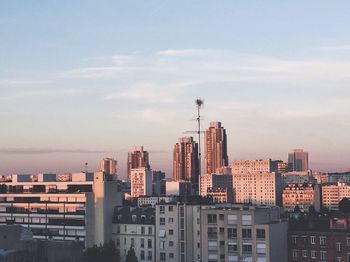 Modern buildings against cloudy sky