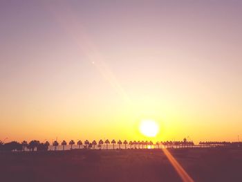 Silhouette of people in city at sunset