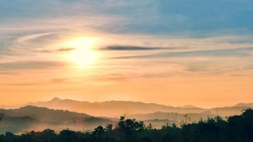 Scenic view of silhouette mountains against sky at sunset