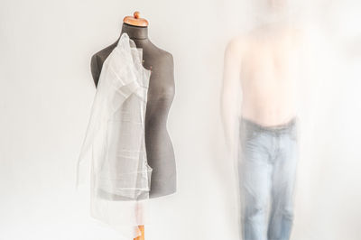 Close-up of clothes hanging on white background