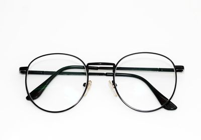 Close-up of eyeglasses against white background