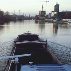 Boats in river with buildings in background