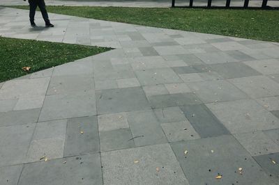Low section of man standing on cobblestone