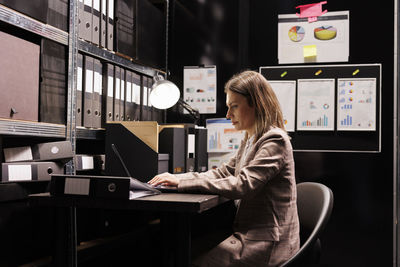 Portrait of young woman using laptop at home