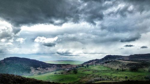 Scenic view of landscape against cloudy sky