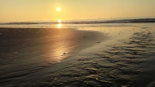 Scenic view of beach against sky during sunset