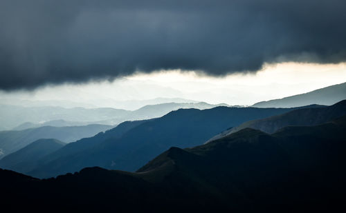 Scenic view of silhouette mountains against sky