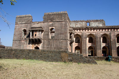 Low angle view of historical building against clear blue sky