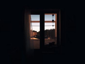 Silhouette of building seen through window